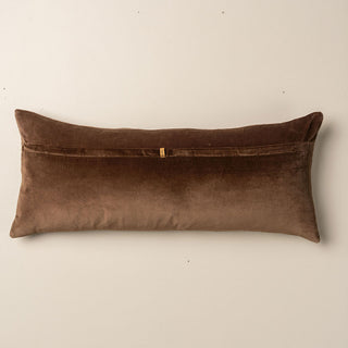 Brown velvet pillow on a beige background