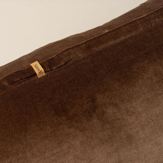 Brown fabric with a brand tag on a beige background
