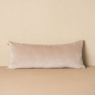 Beige pillow on a beige surface with a neutral background